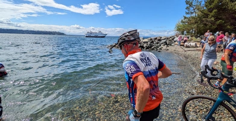 Bike the US for MS rider running to water