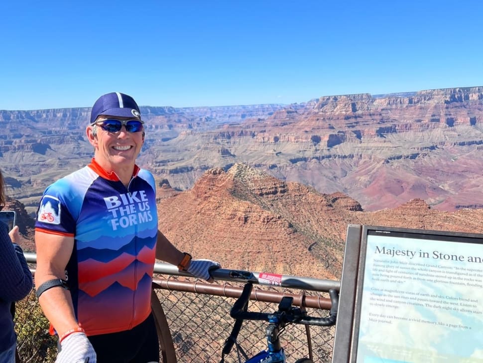 Bike the US for MS rider smiling infront of the Grand Canyon on Grand Canyon bike tour