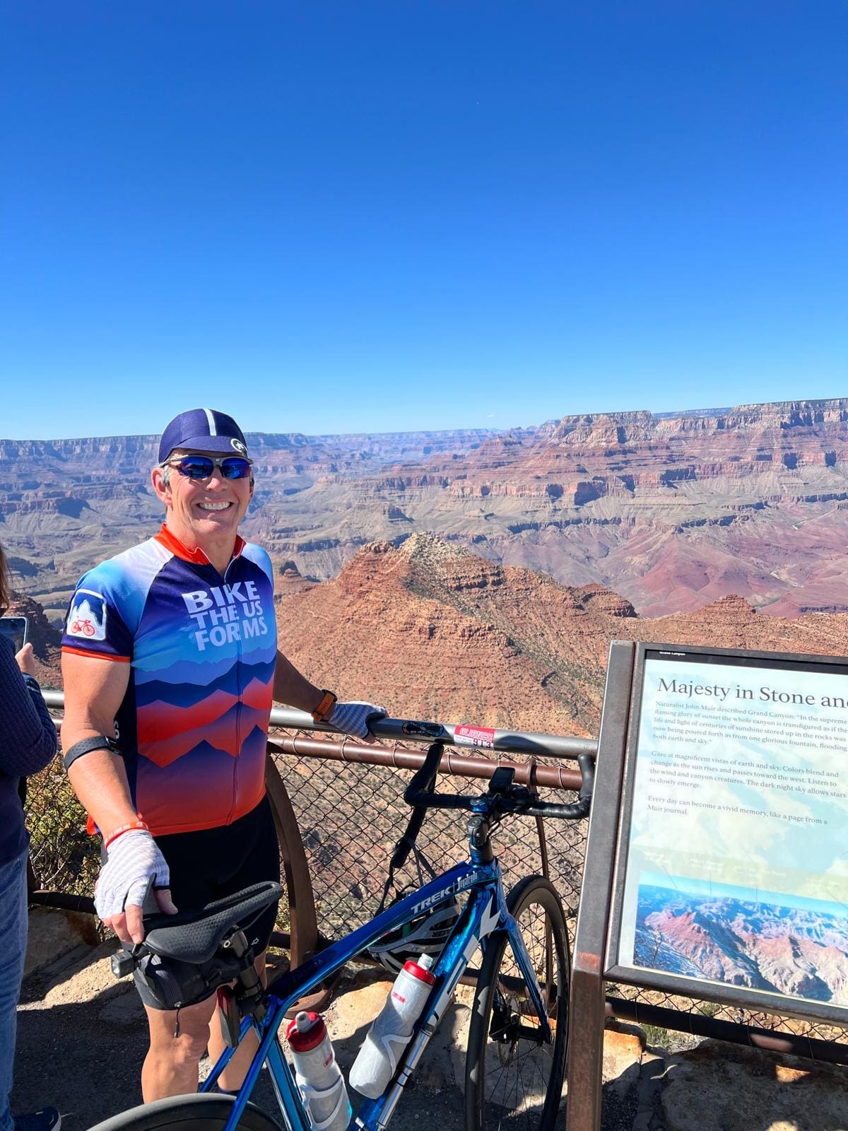 Bike the US for MS rider smiling infront of the Grand Canyon on Grand Canyon bike tour