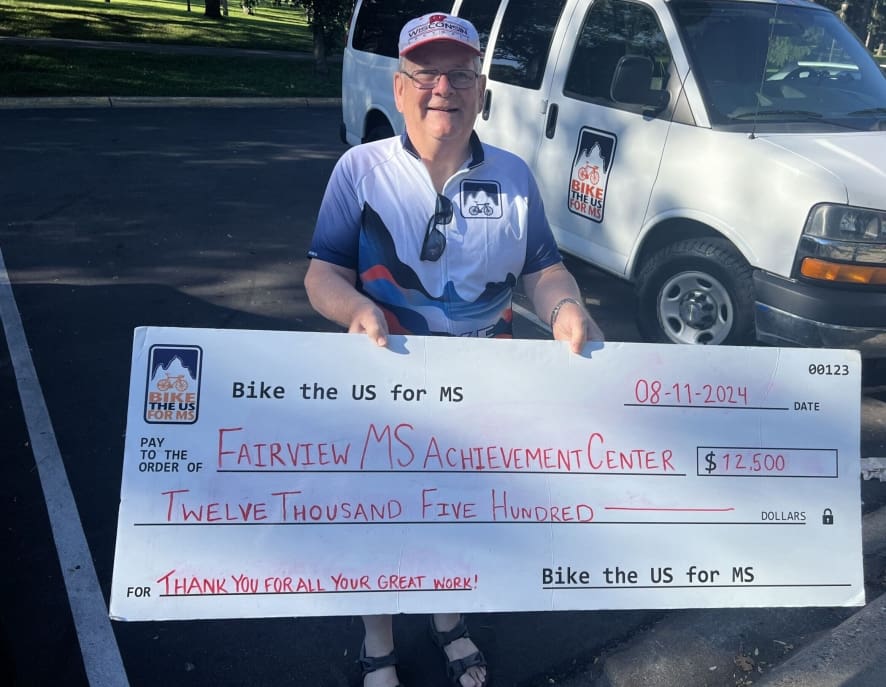 Bike the US for MS rider with check